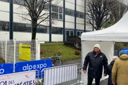 Agent de sécurité surveillant l'entrée d'un bâtiment d'entreprise pour assurer la protection des lieux et des collaborateurs.